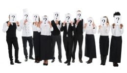 Restaurant Staff Hiding Faces With Question Mark Signs